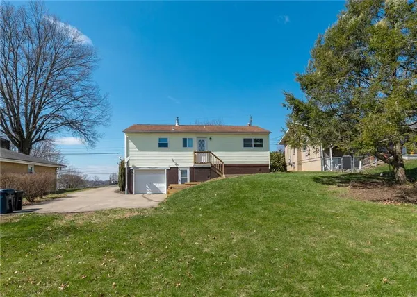 a view of a house with a back yard