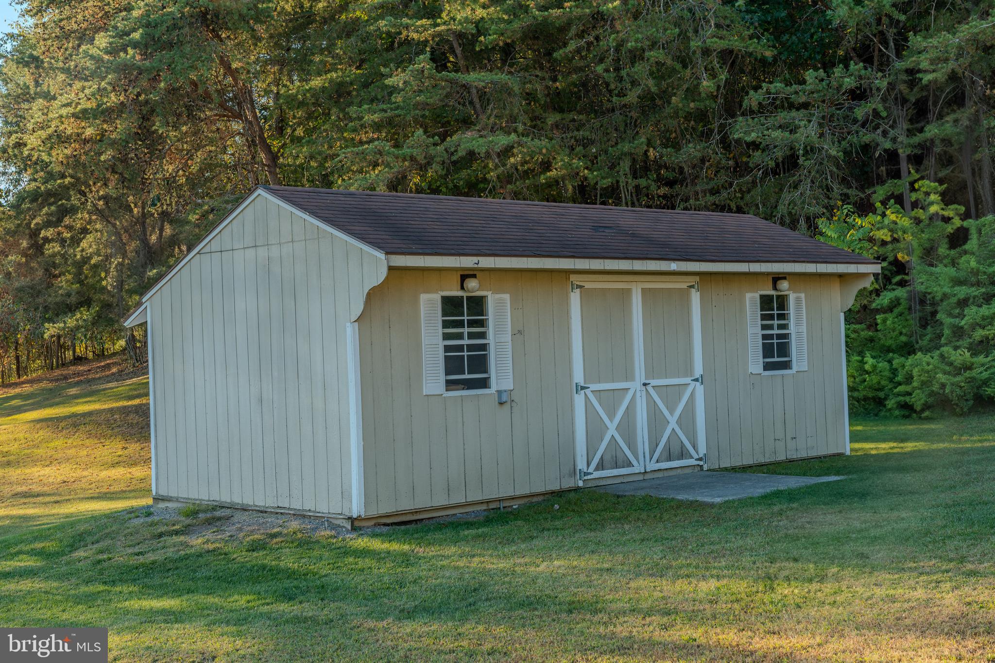 105 Shrefflers Lane McClure, PA 17841 - Photo 14 of 48 a backyard of a house with lawn chairs plants and large tree