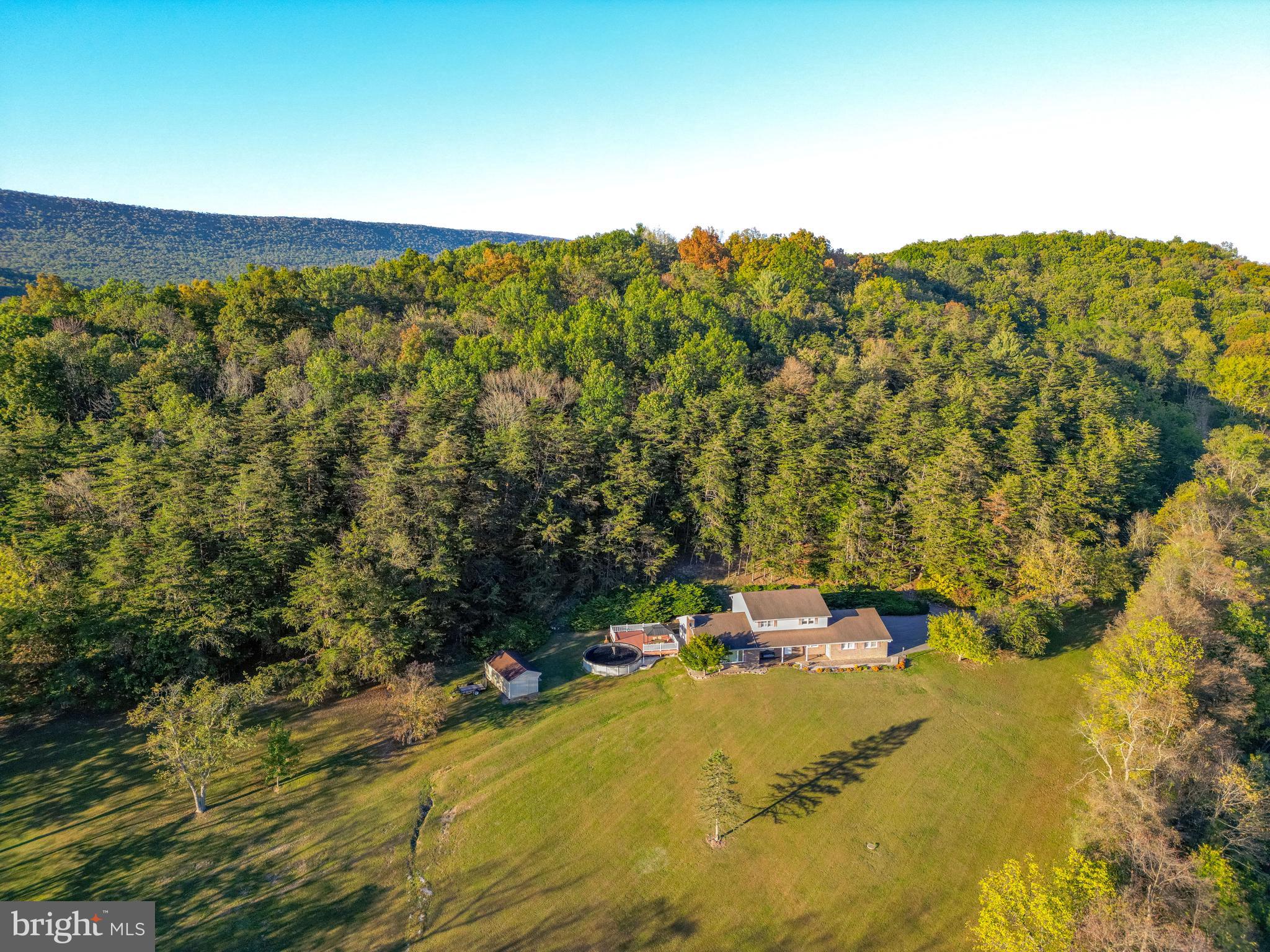 105 Shrefflers Lane McClure, PA 17841 - Photo 2 of 48 a view of a lake with a building in the background