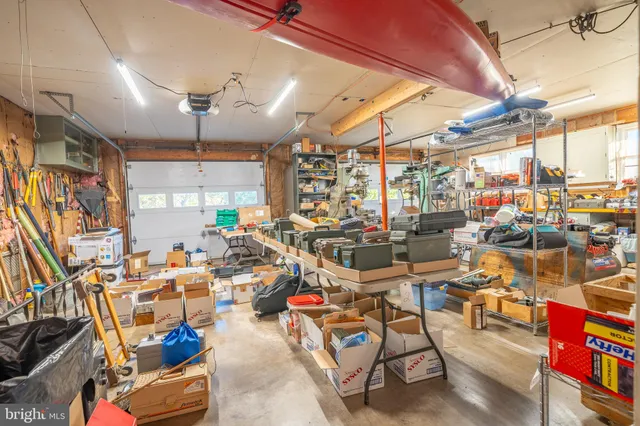 a kitchen with stainless steel appliances a refrigerator a table and chairs