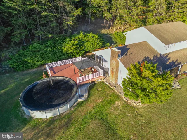 an aerial view of a house with garden space and street view