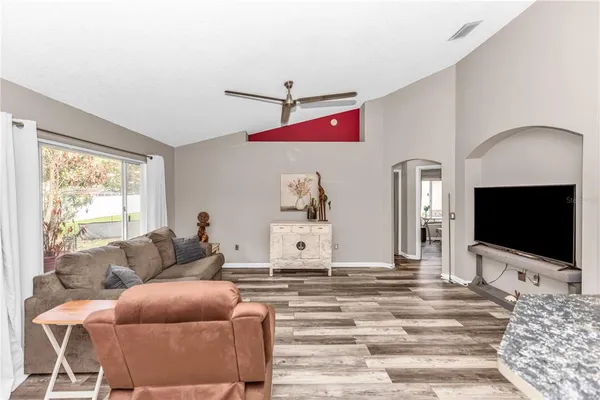 a view of a livingroom with a ceiling fan and window