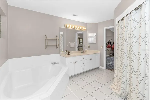 a bedroom with furniture and a large window