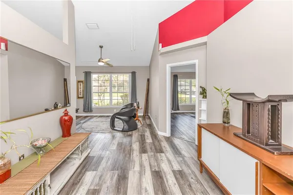 a view of living room filled with furniture and flat screen tv