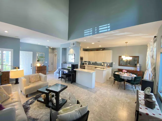 a living room with furniture and kitchen view