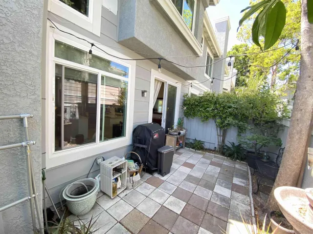 a view of a patio with chair and tables back yard of the house