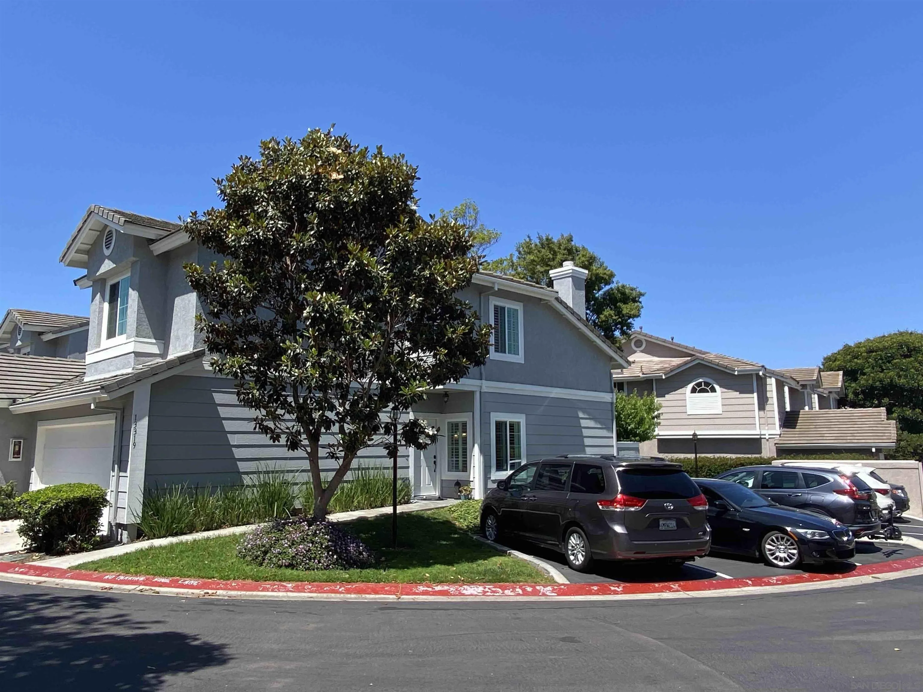 13319 Kibbings Road San Diego, CA 92130 - Photo 2 of 32 a car parked in front of a white house