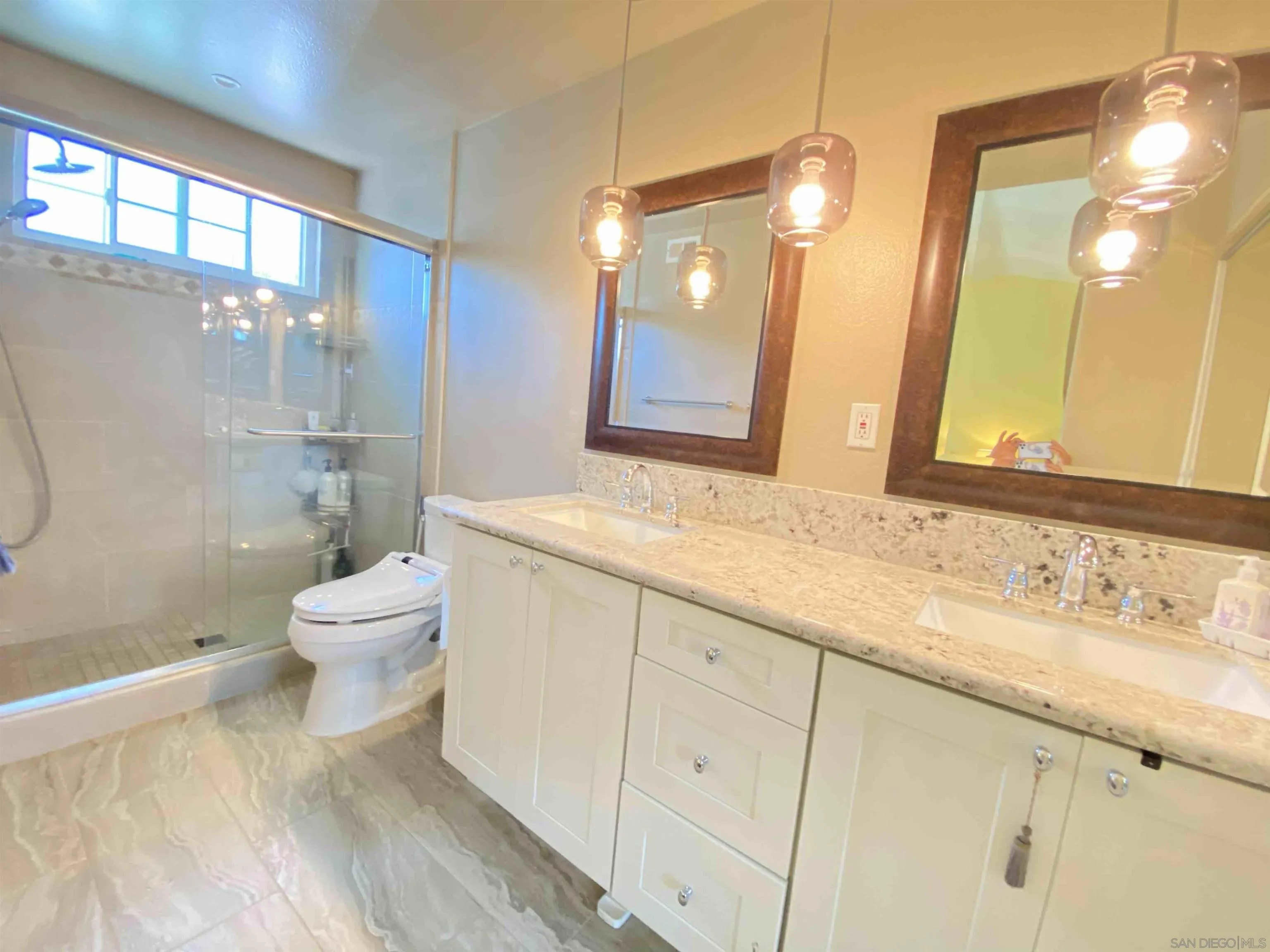 13319 Kibbings Road San Diego, CA 92130 - Photo 25 of 32 a bathroom with a sink a toilet and shower