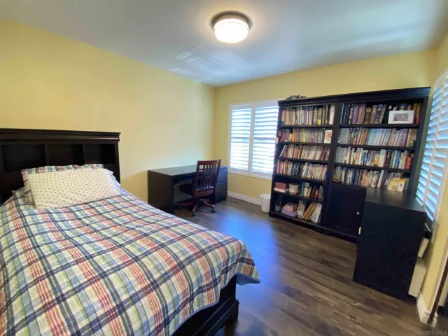 a bedroom with a bed furniture and a book shelf