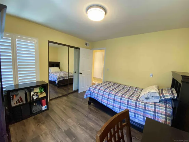 a bed room with a bed chair and a window