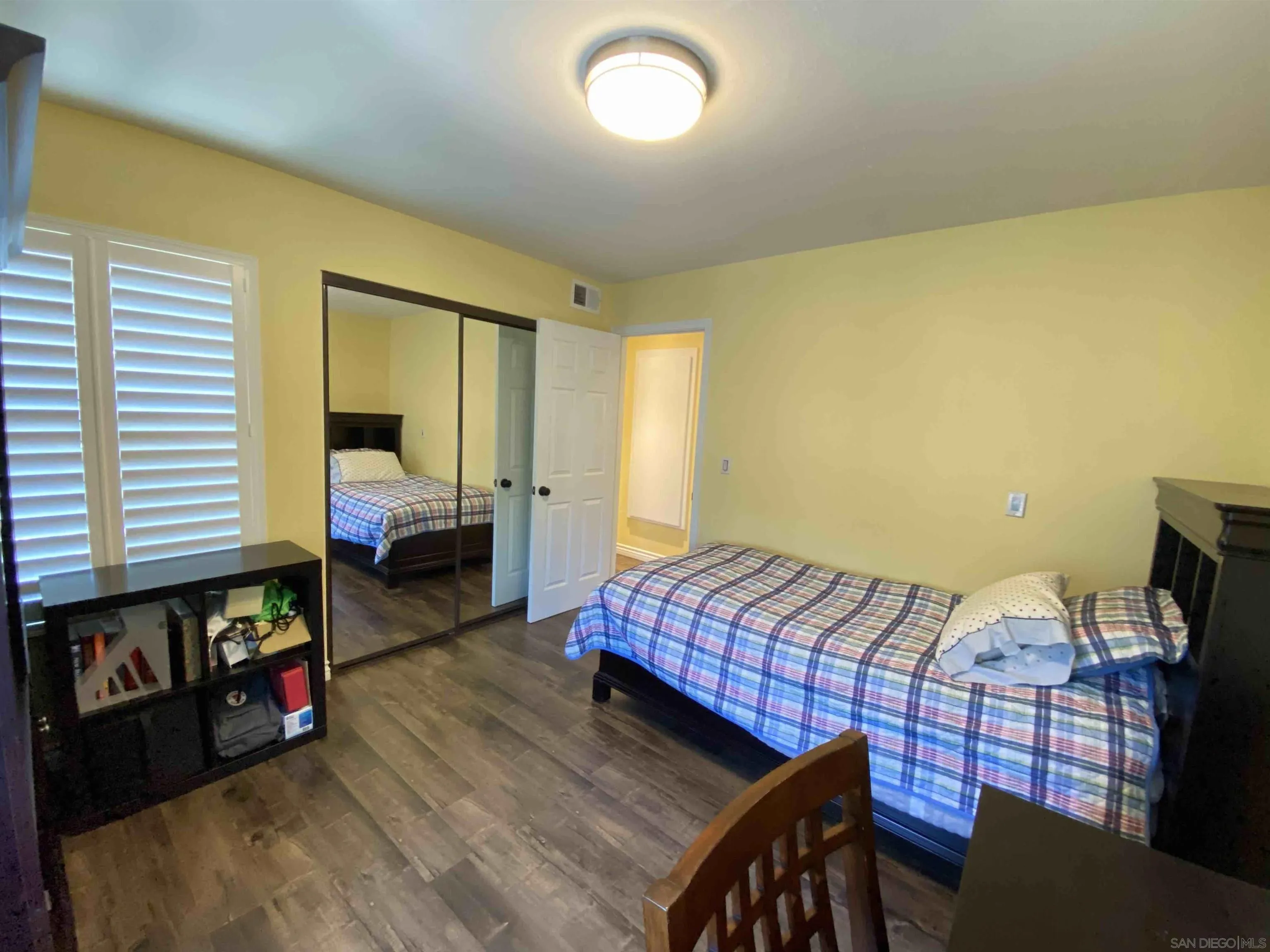 13319 Kibbings Road San Diego, CA 92130 - Photo 29 of 32 a bed room with a bed chair and a window