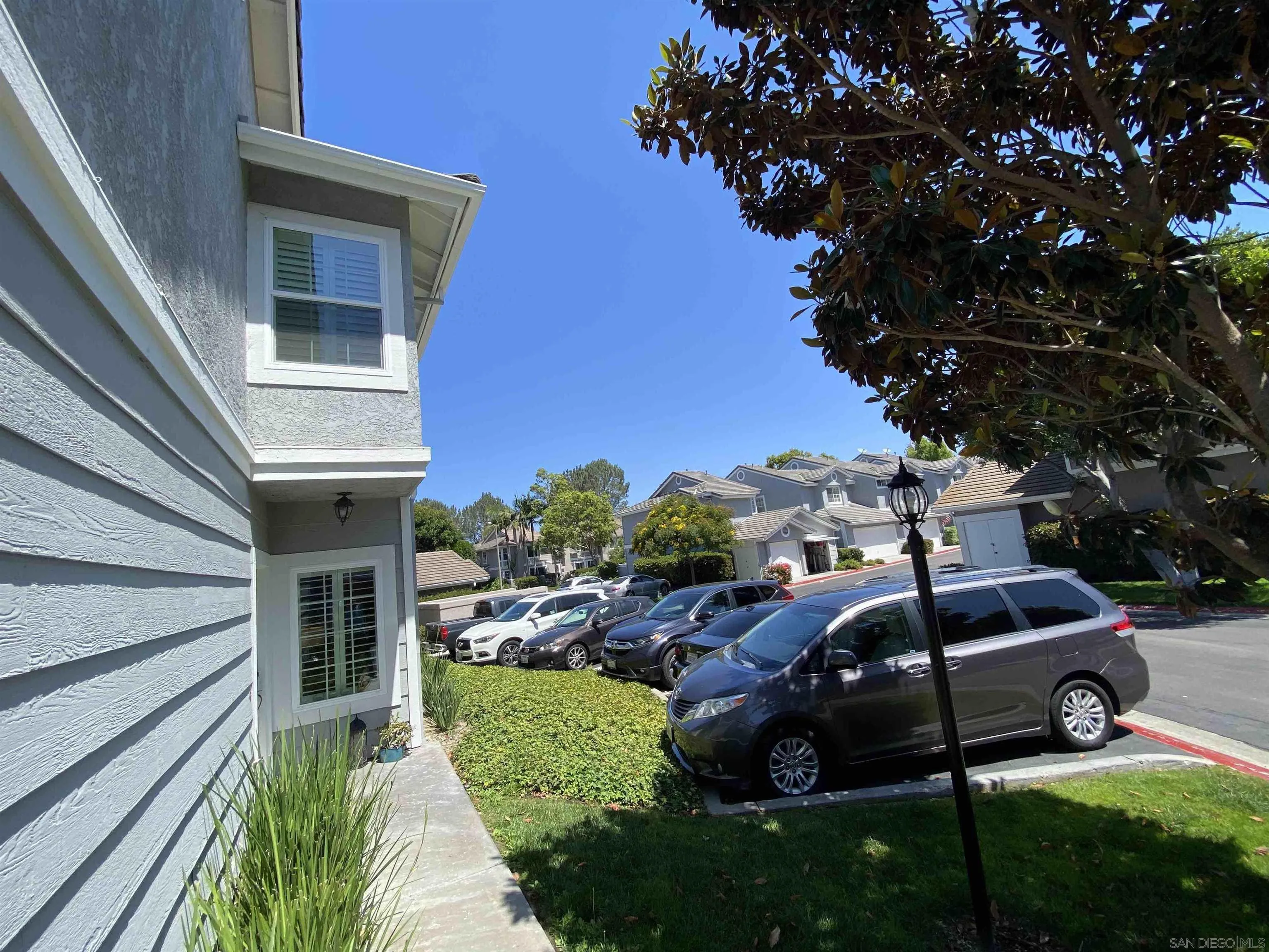 13319 Kibbings Road San Diego, CA 92130 - Photo 3 of 32 a view of a garden with cars parked