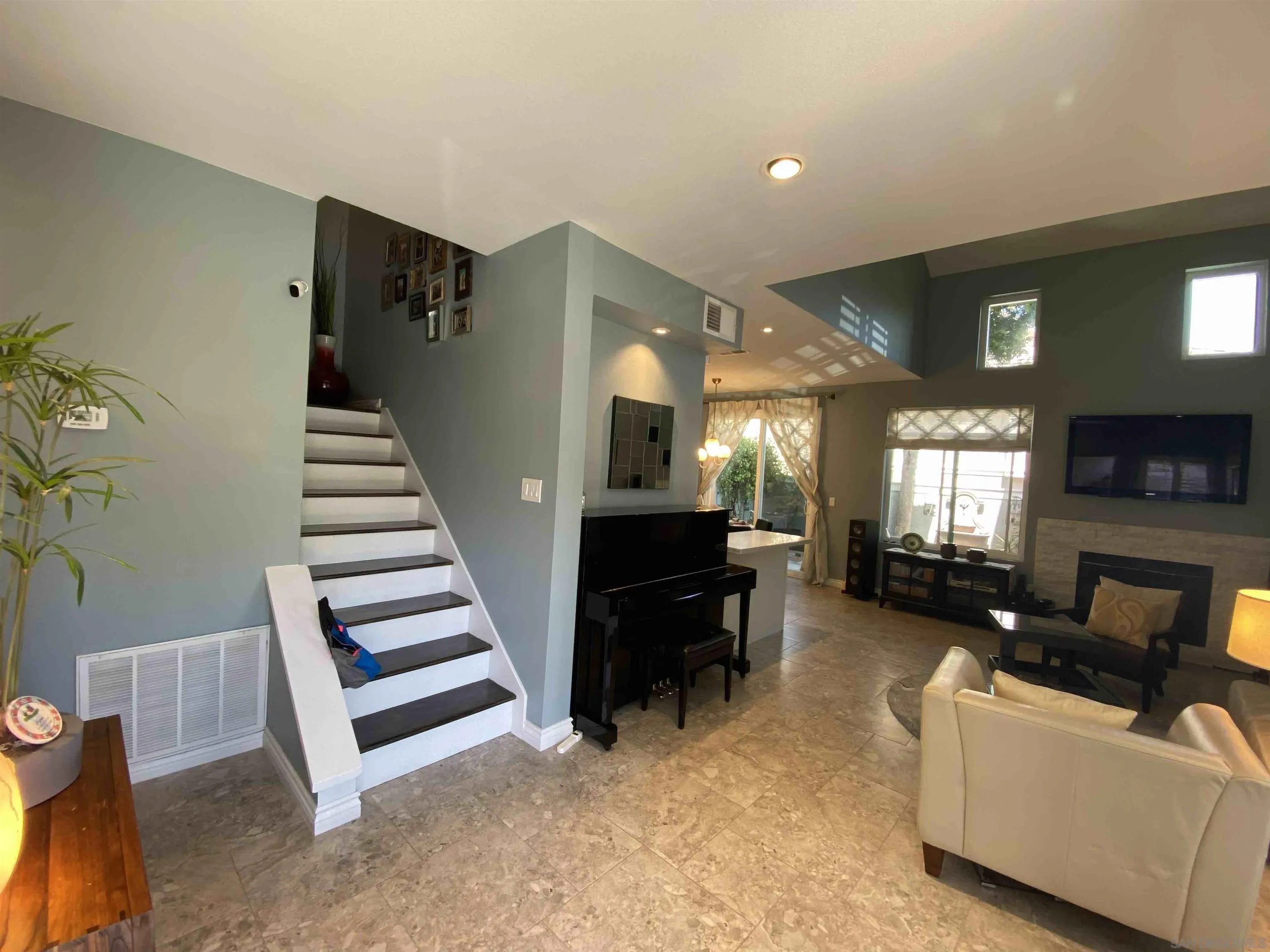 13319 Kibbings Road San Diego, CA 92130 - Photo 4 of 32 a living room with furniture and a flat screen tv