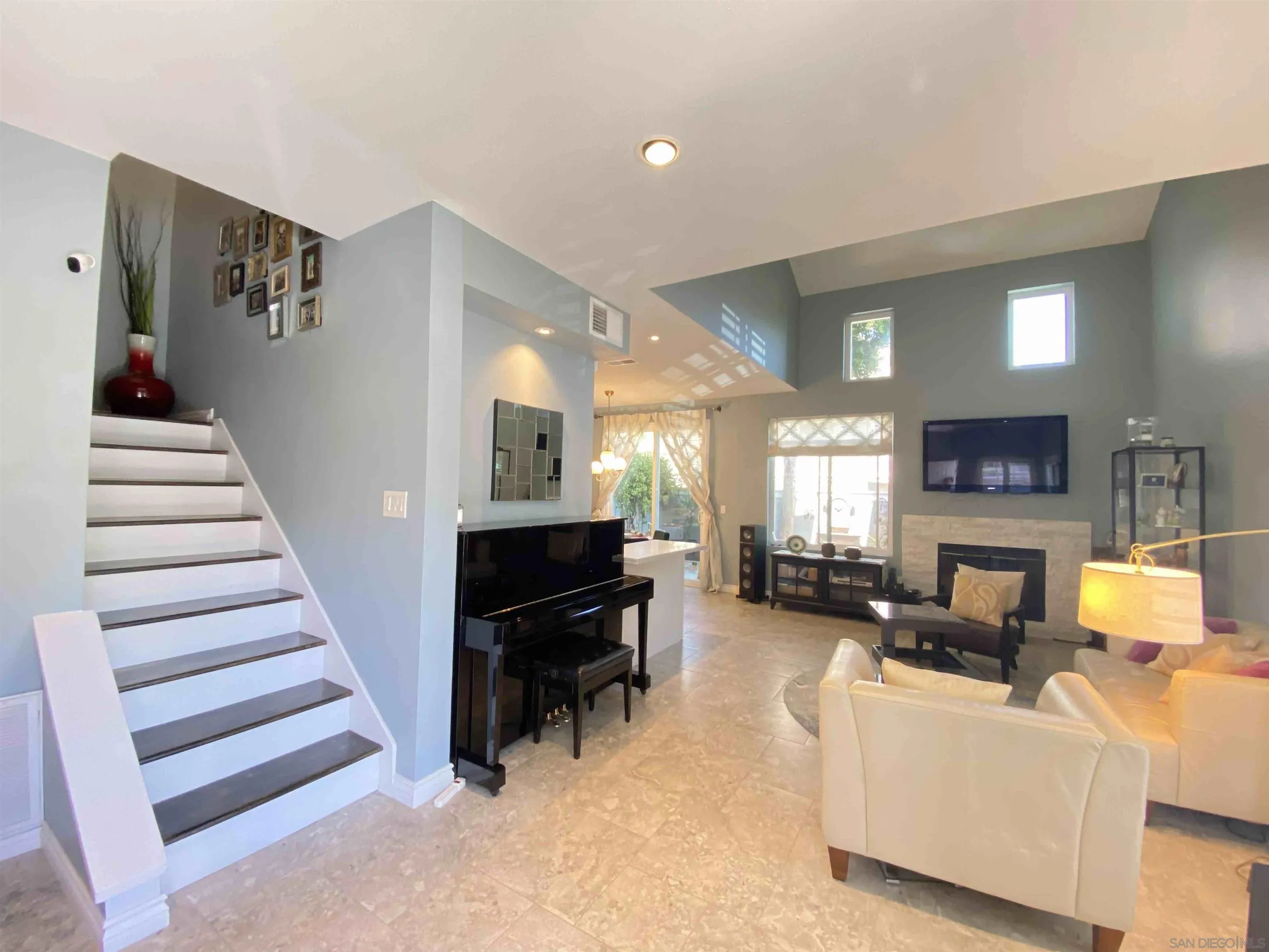 13319 Kibbings Road San Diego, CA 92130 - Photo 8 of 32 a living room with furniture and a fireplace