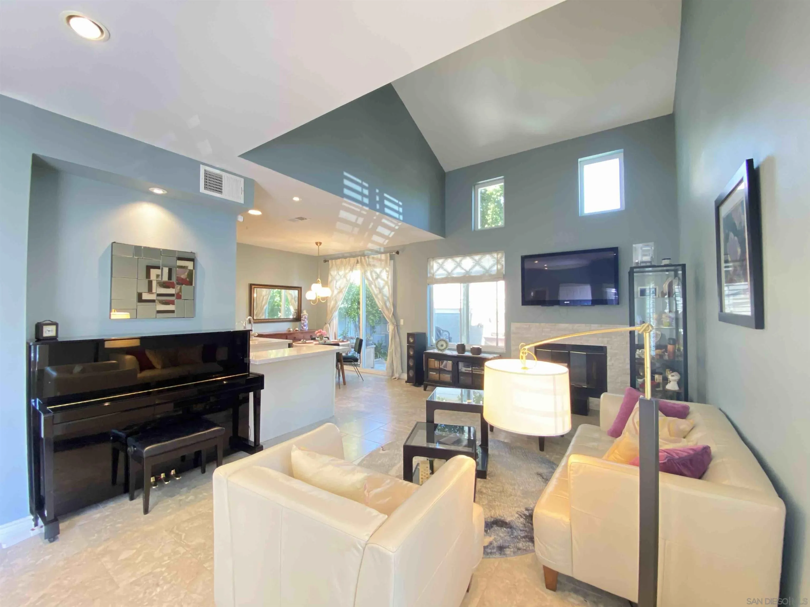 13319 Kibbings Road San Diego, CA 92130 - Photo 9 of 32 a living room with furniture and a flat screen tv