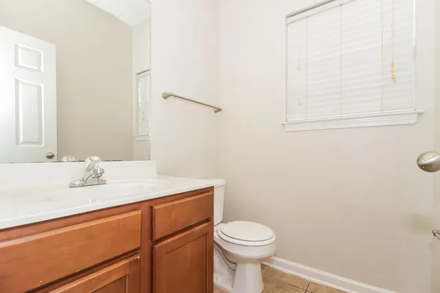 a bathroom with a sink a toilet and mirror