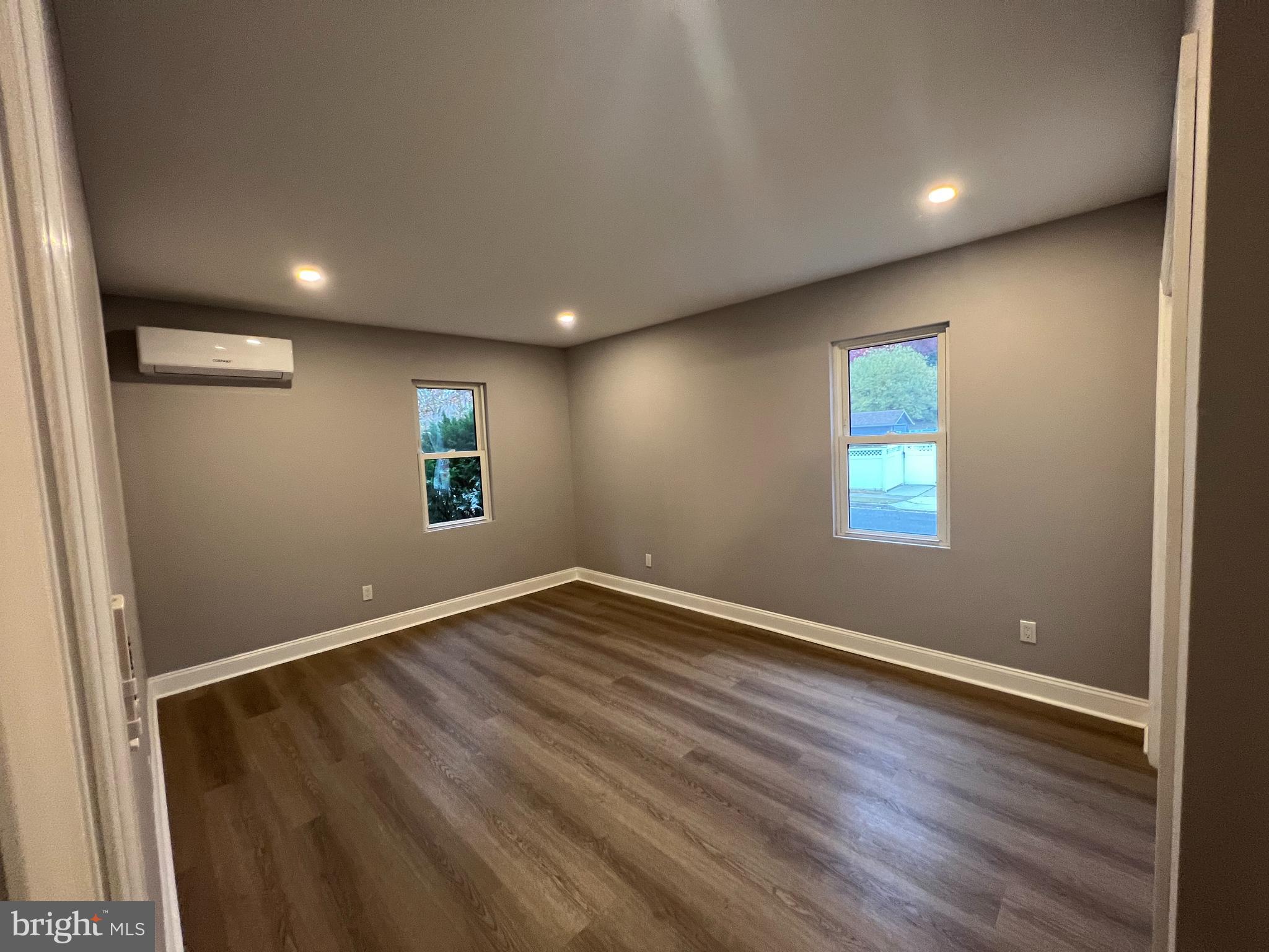 1301 Newton Avenue, Unit A Haddon Township, NJ 08107 - Photo 12 of 13 an empty room with wooden floor and windows