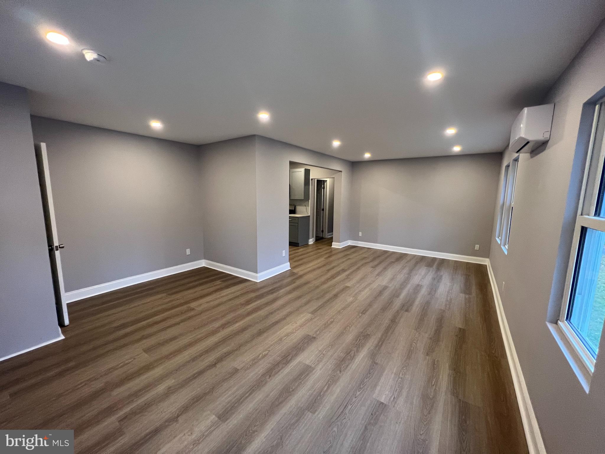 1301 Newton Avenue, Unit A Haddon Township, NJ 08107 - Photo 6 of 13 an empty room with wooden floor and windows