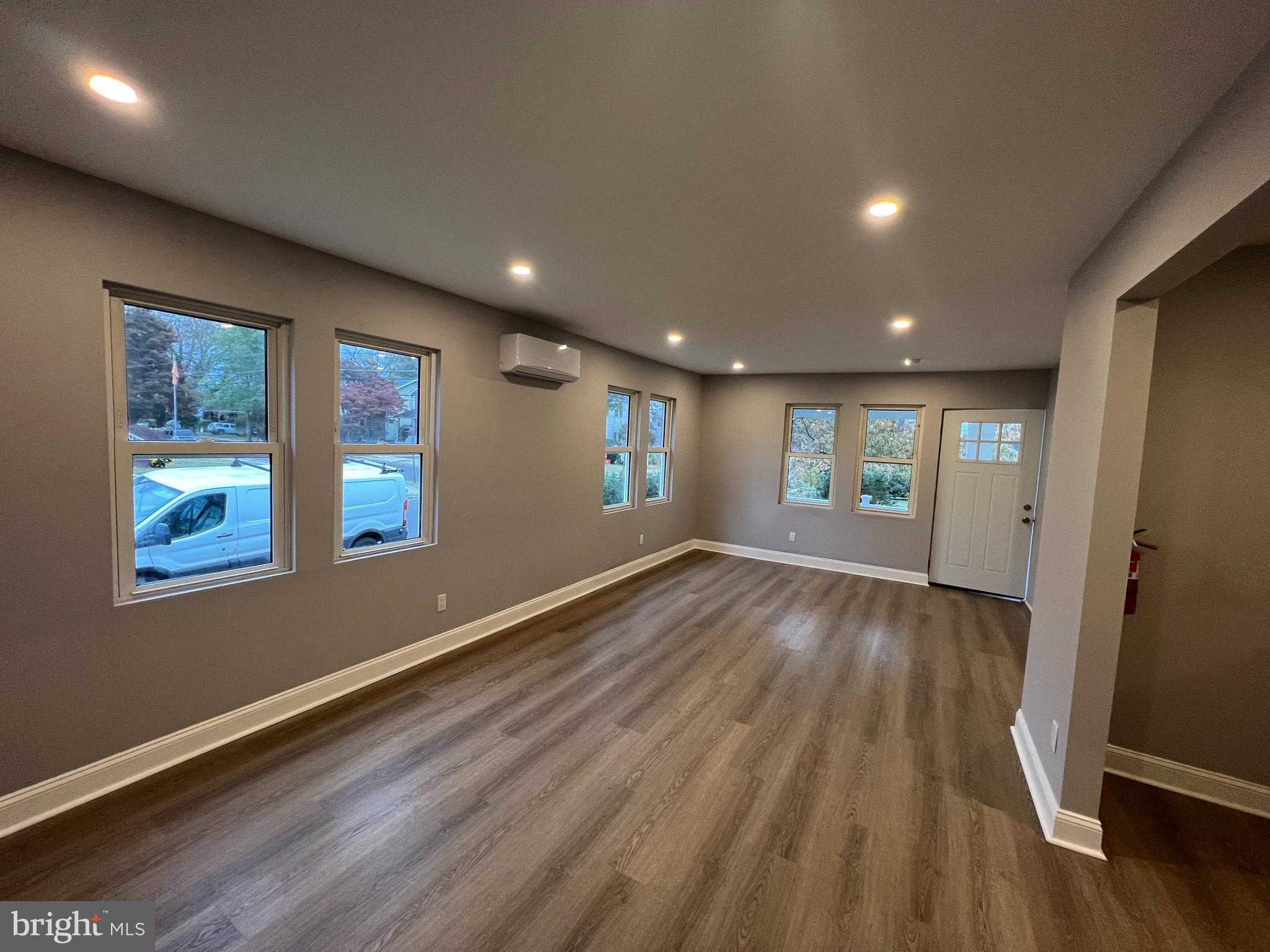 1301 Newton Avenue, Unit A Haddon Township, NJ 08107 - Photo 7 of 13 a view of an empty room with wooden floor and a window