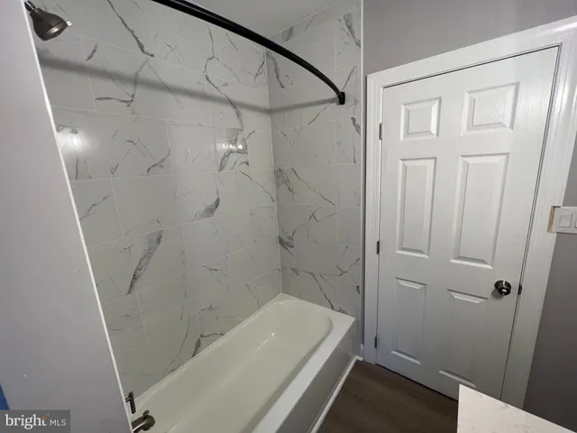 a bathroom with a tub and shower