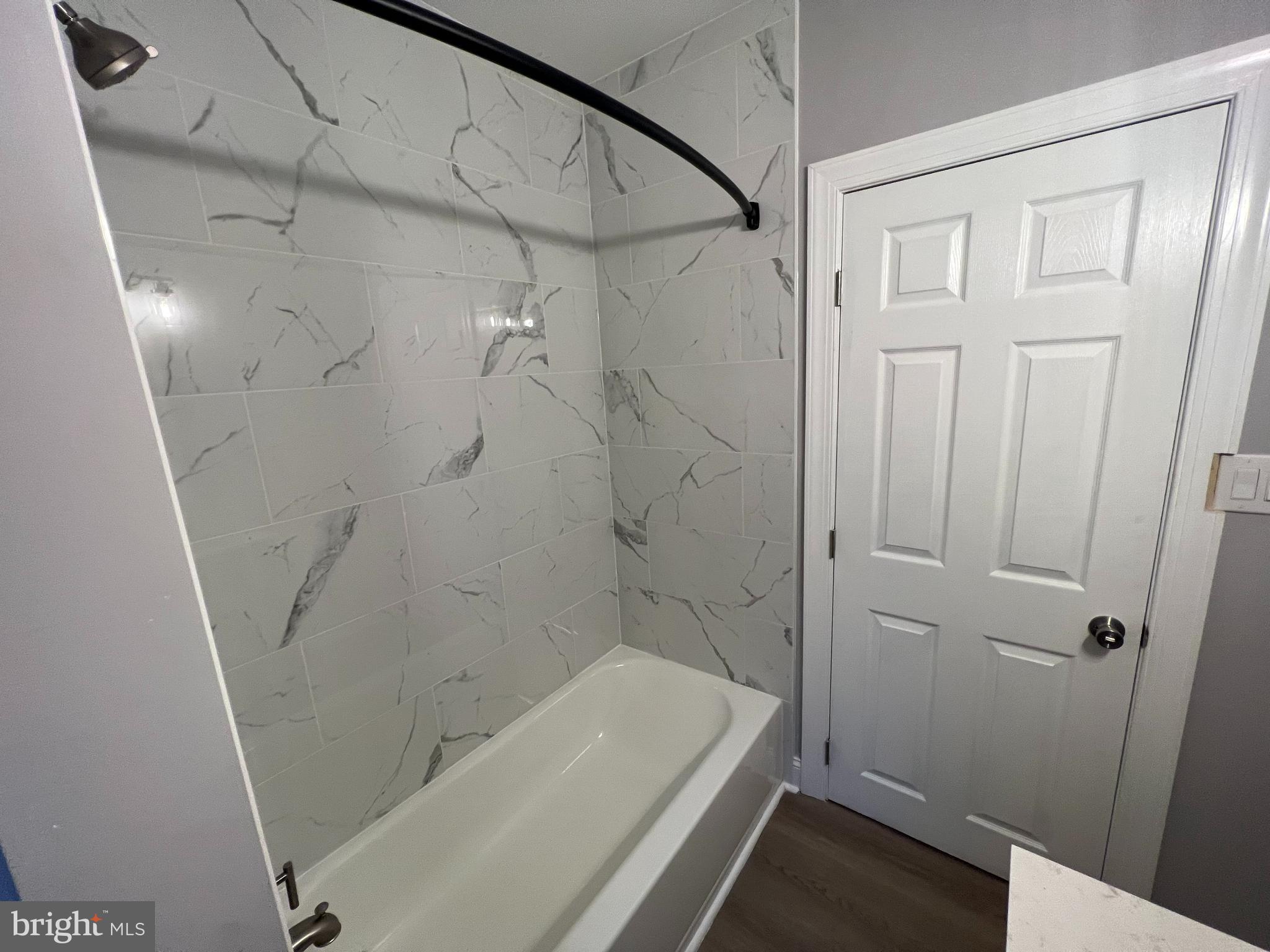 1301 Newton Avenue, Unit A Haddon Township, NJ 08107 - Photo 9 of 13 a bathroom with a tub and shower