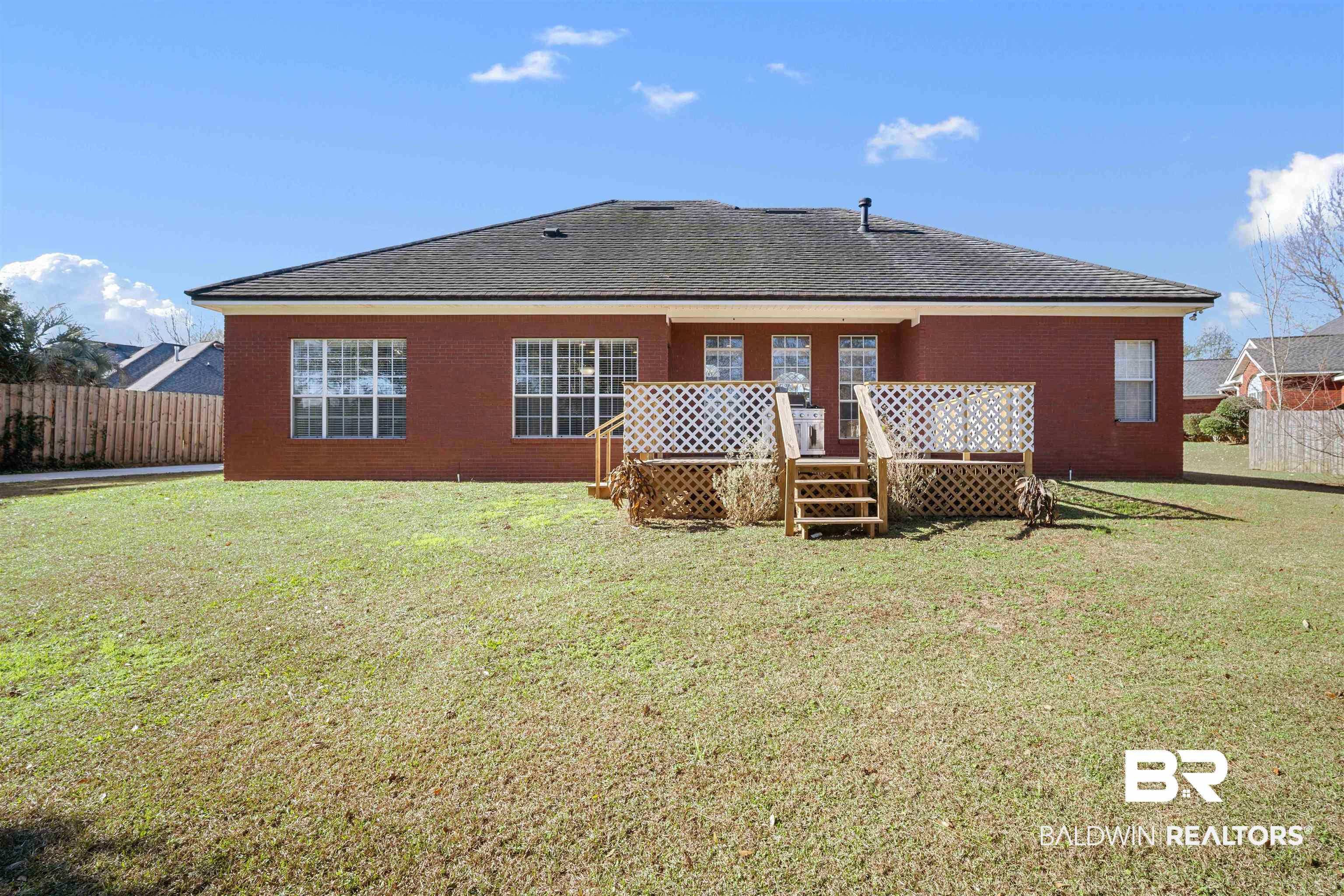 615 Summerlake Place Mobile, AL 36608 - Photo 33 of 35 Rear view of house with a deck, brick siding, and roof with shingles