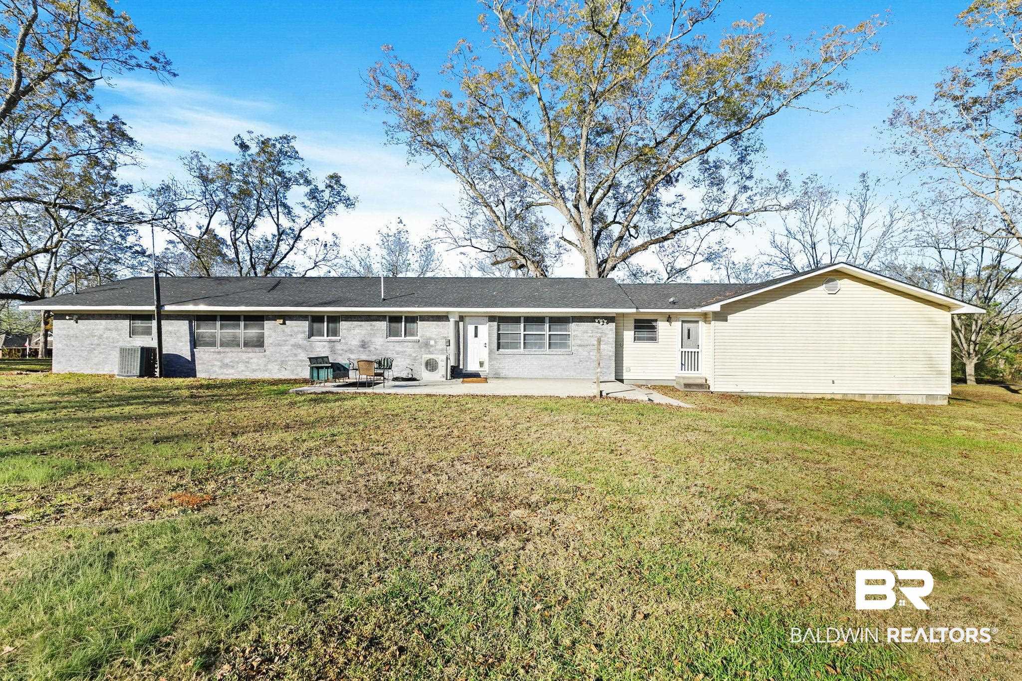 21267 Loop Road Andalusia, AL 36421 - Photo 52 of 72 Back of property featuring a lawn and a patio area