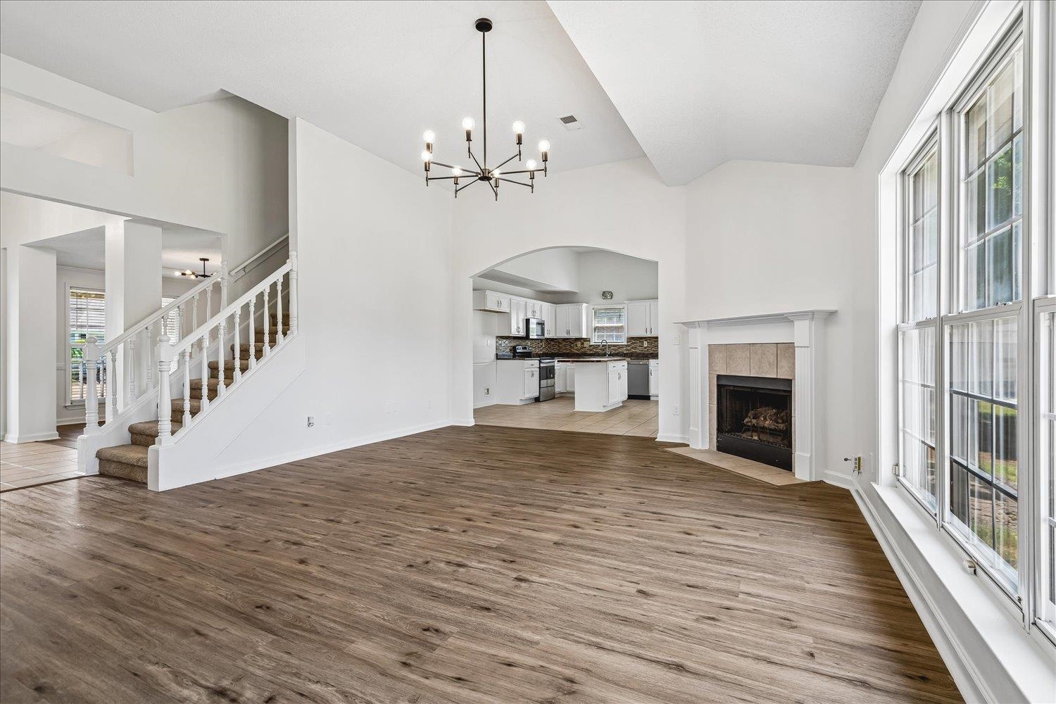 6335 Needle Ridge Road Bartlett, TN 38135 - Photo 9 of 25 Spacious room with wood-finish flooring and a central chandelier
