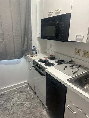 a kitchen with a sink and cabinets