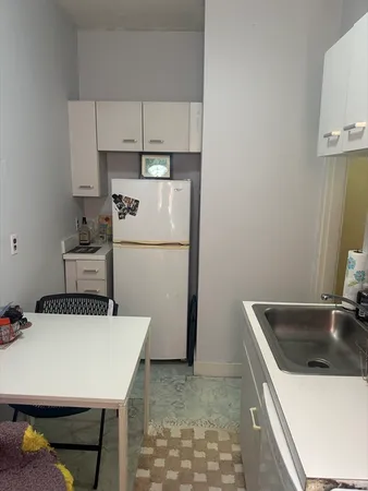 a kitchen with a refrigerator a sink and a stove