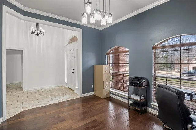 a view of a livingroom with wooden floor and windows