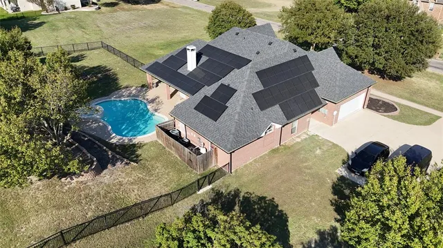 an aerial view of residential houses with outdoor space