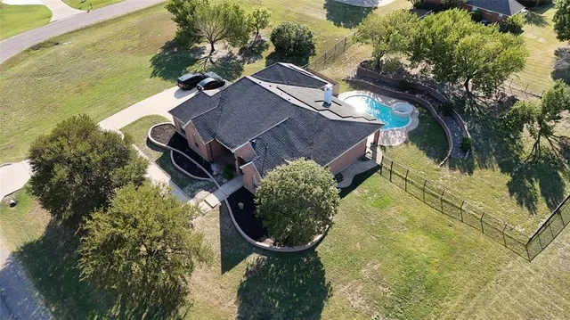 an aerial view of a house with yard swimming pool and outdoor seating