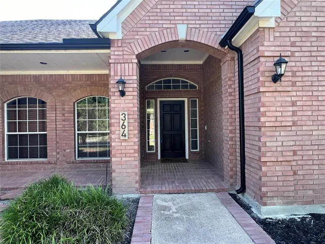 a front view of a house with large windows