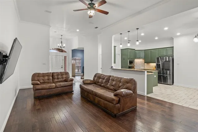 a living room with furniture and kitchen view