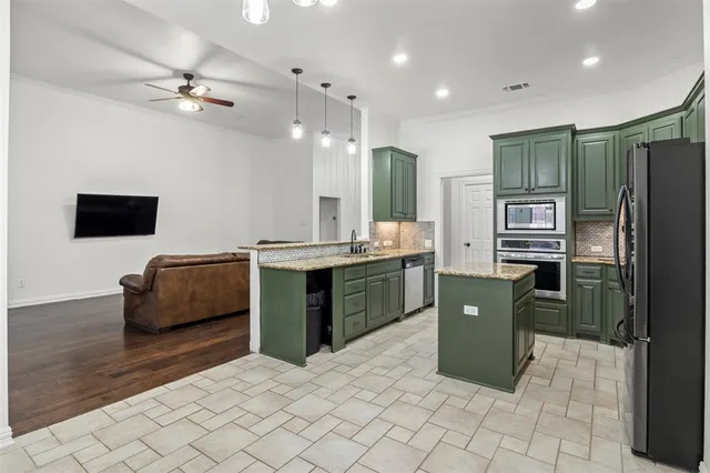 a kitchen with stainless steel appliances granite countertop a refrigerator a oven a sink and dishwasher