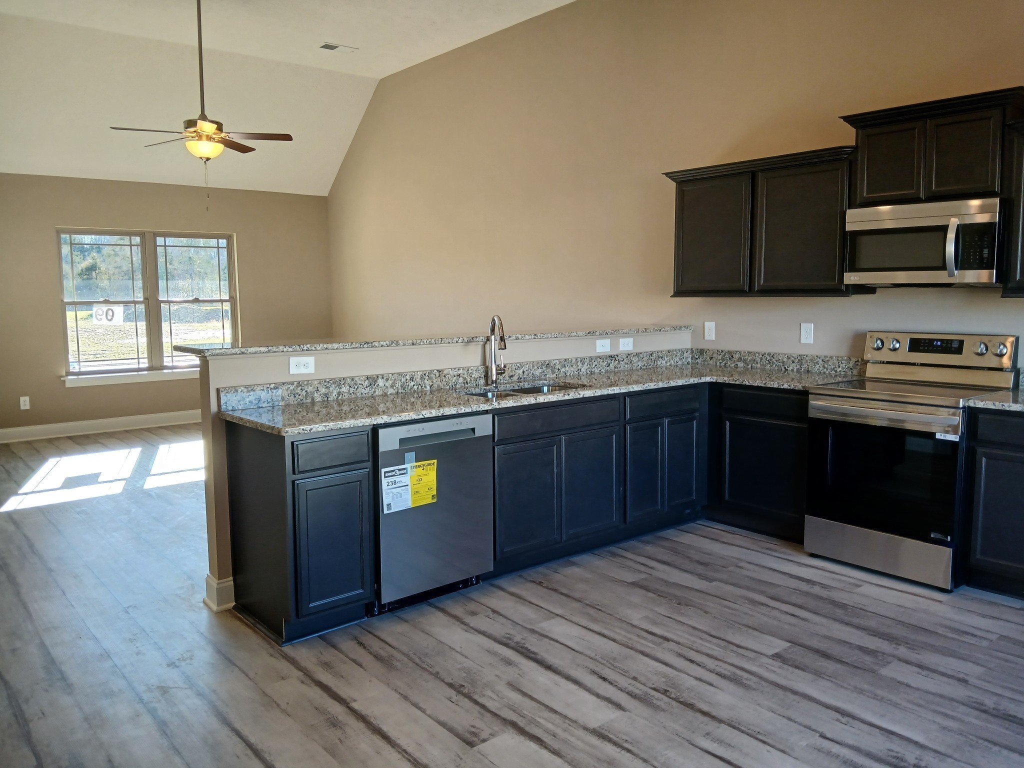 2819 Upstream Road Christiana, TN 37037 - Photo 12 of 95 a kitchen with stainless steel appliances granite countertop wooden cabinets a sink dishwasher and a stove with wooden floor