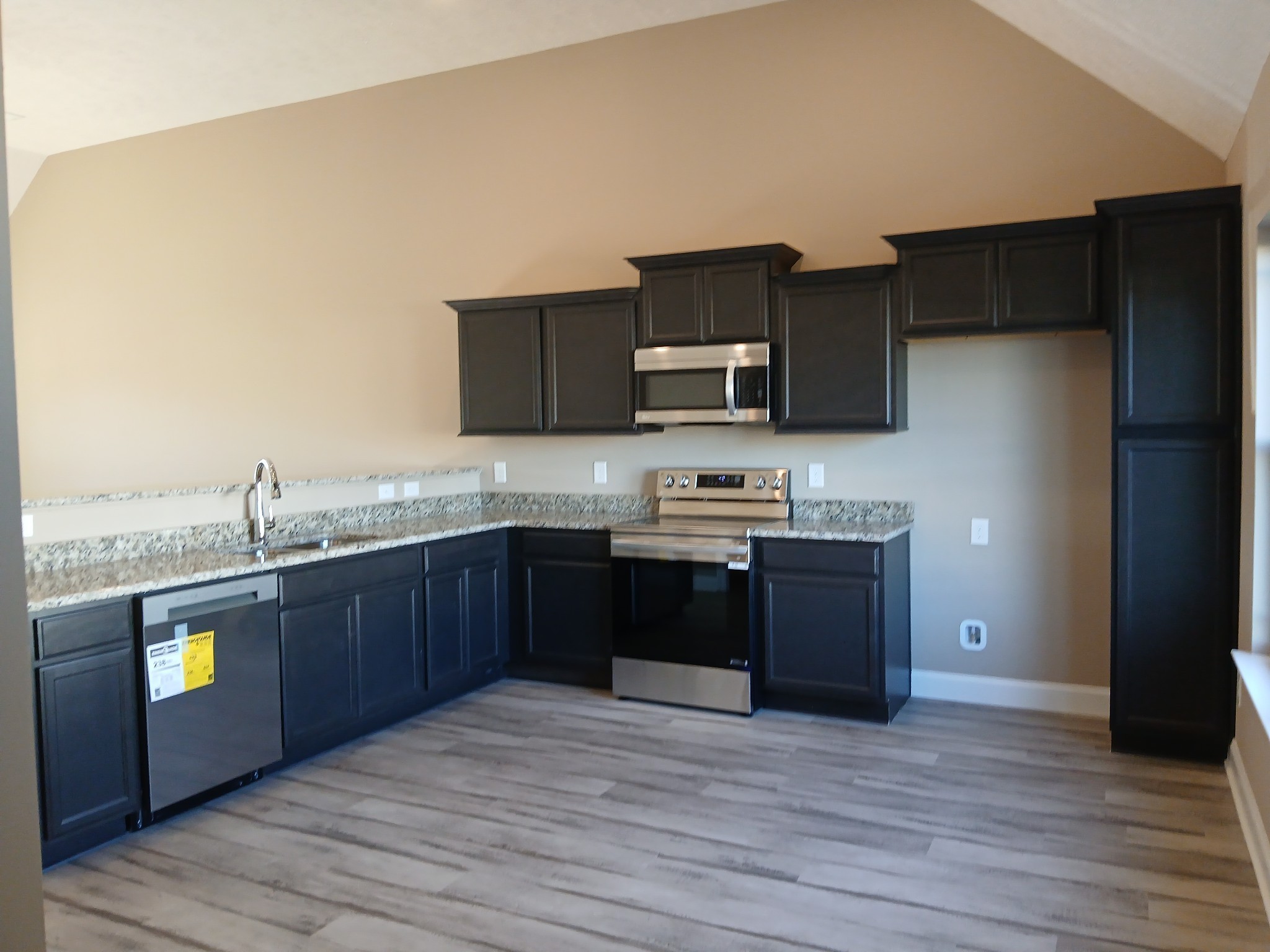 2819 Upstream Road Christiana, TN 37037 - Photo 55 of 95 a large kitchen with kitchen island granite countertop wooden cabinets a stove a sink and a refrigerator