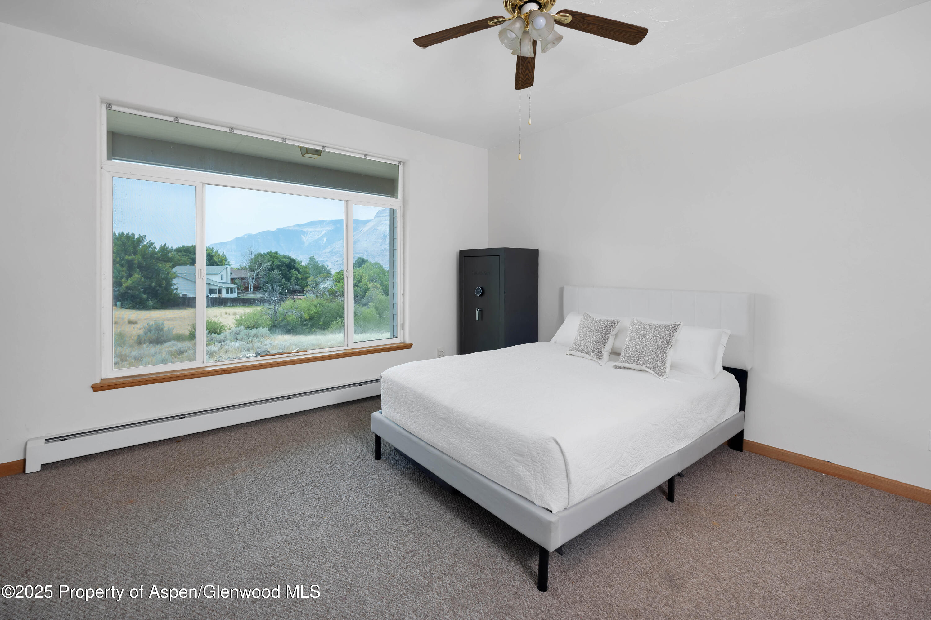 250 Limberpine Circle Battlement Mesa, CO 81635 - Photo 17 of 34 a large bed sitting in a room next to a window