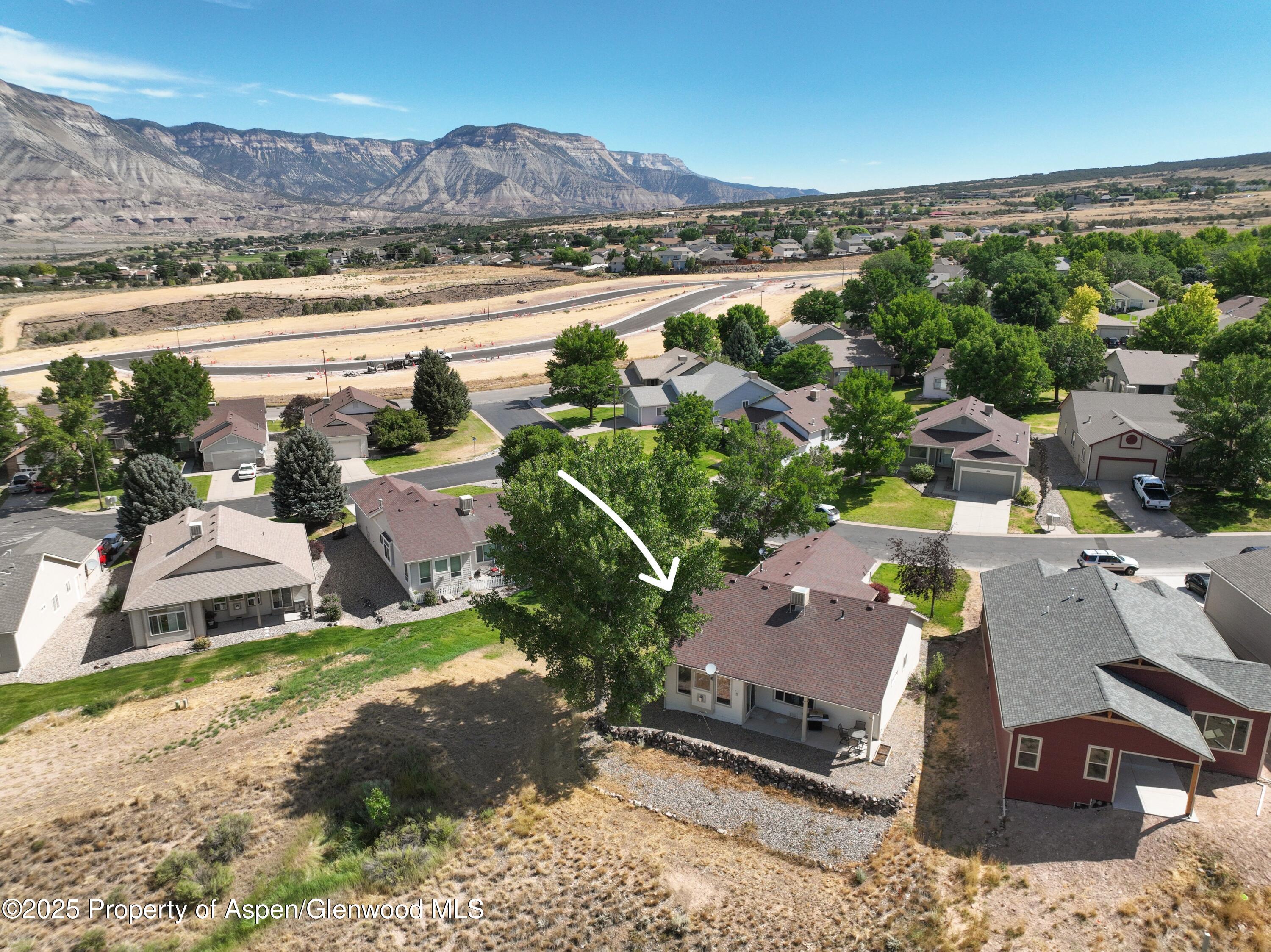 250 Limberpine Circle Battlement Mesa, CO 81635 - Photo 30 of 34 an aerial view of a house with garden space and mountain view in back
