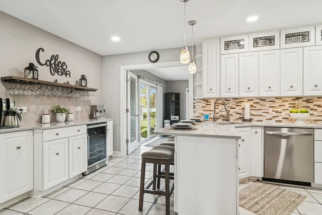 a kitchen with granite countertop white cabinets and appliances