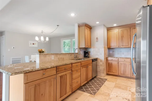 a living room with furniture and a view of kitchen