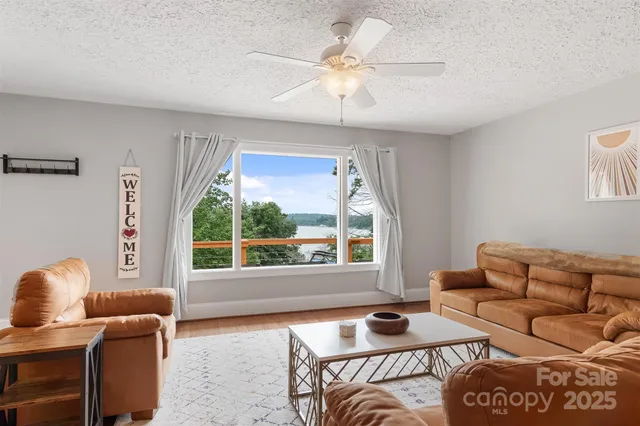 a living room with furniture and a view of kitchen
