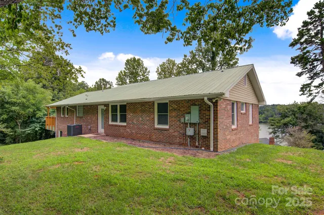 a backyard of a house with table and chairs