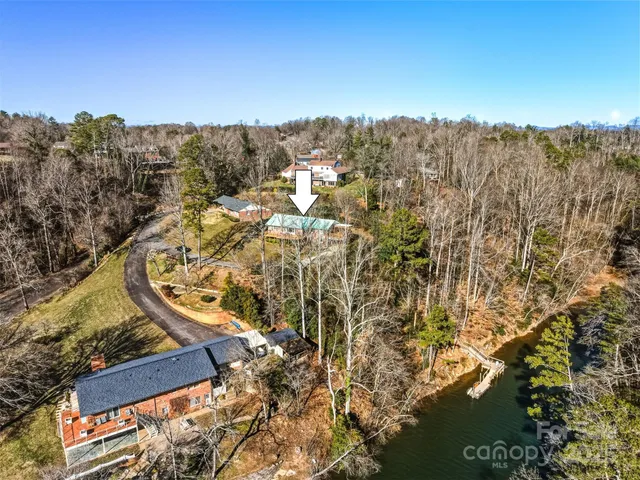 an aerial view of a house with a lake view