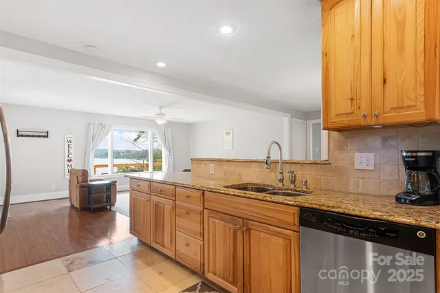 a large bathroom with a granite countertop sink a large mirror and a bathtub