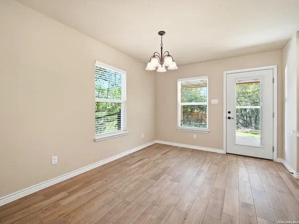 a view of livingroom with window wooden floor and chandelier