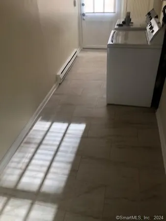 a kitchen with white cabinets and white appliances