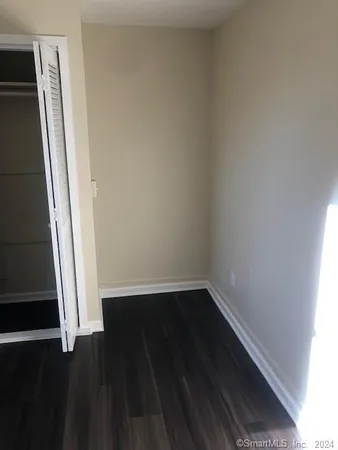 a bathroom with a sink and mirror with toilet