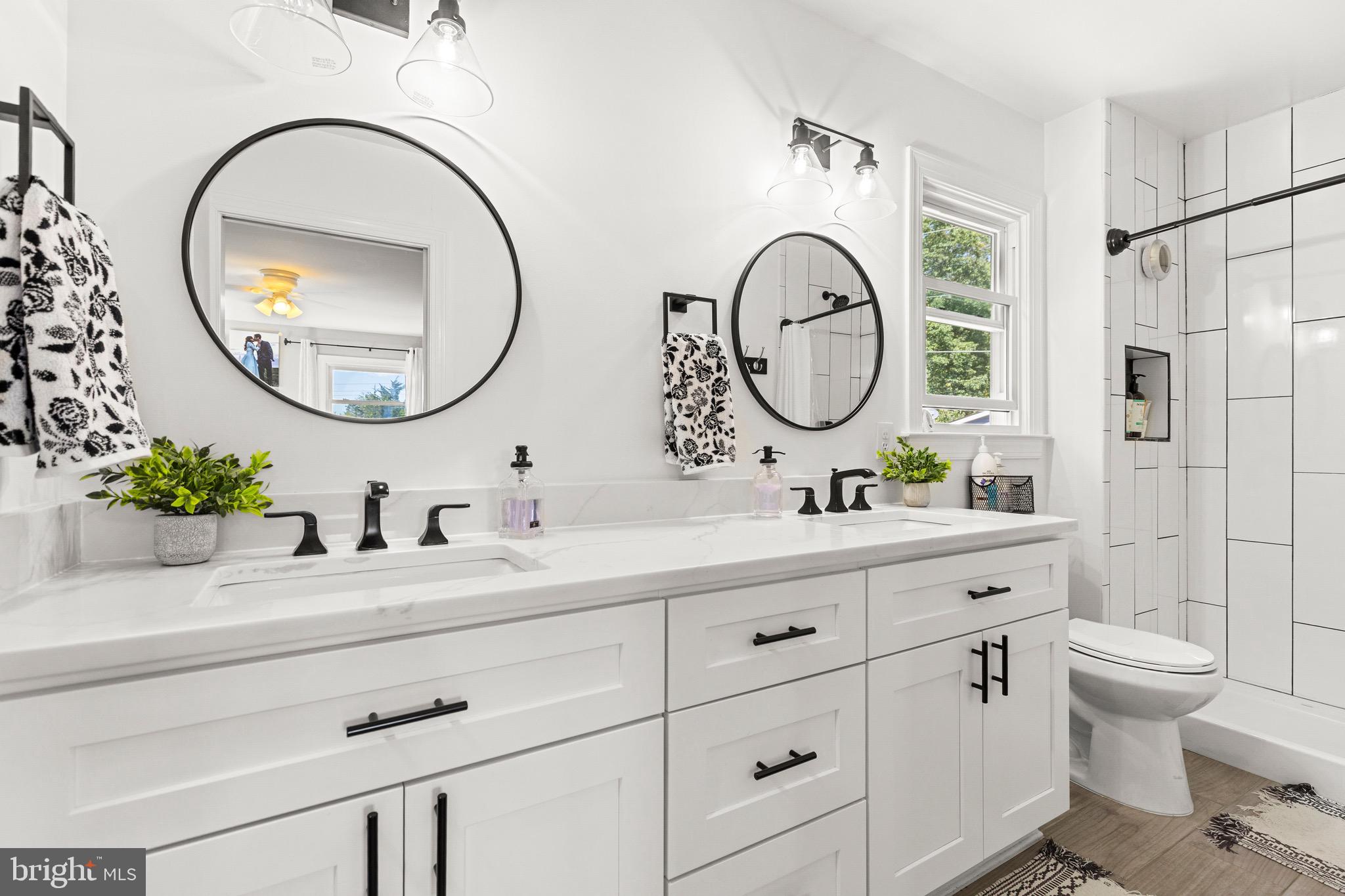 6666 Kelly Road Warrenton, VA 20187 - Photo 15 of 34 a bathroom with a granite countertop toilet a sink and a mirror
